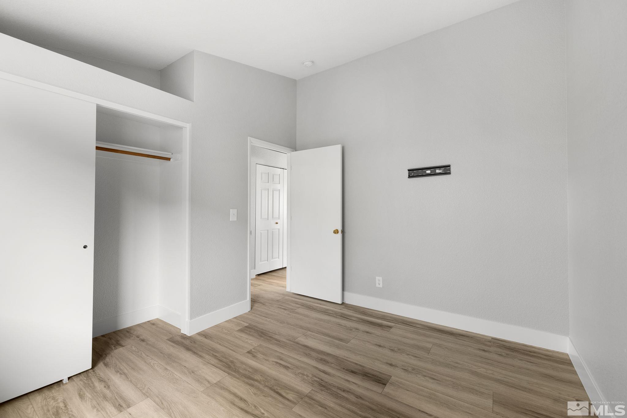 7577 Water View Way Reno, NV 89511 - Photo 12 of 20 a view of an empty room with wooden floor and closet