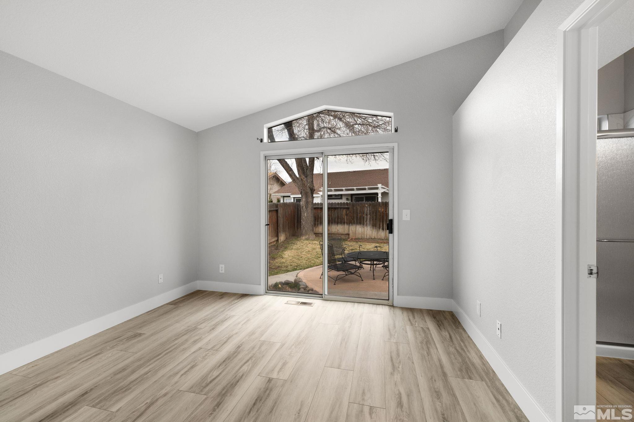 7577 Water View Way Reno, NV 89511 - Photo 13 of 20 an empty room with wooden floor and windows