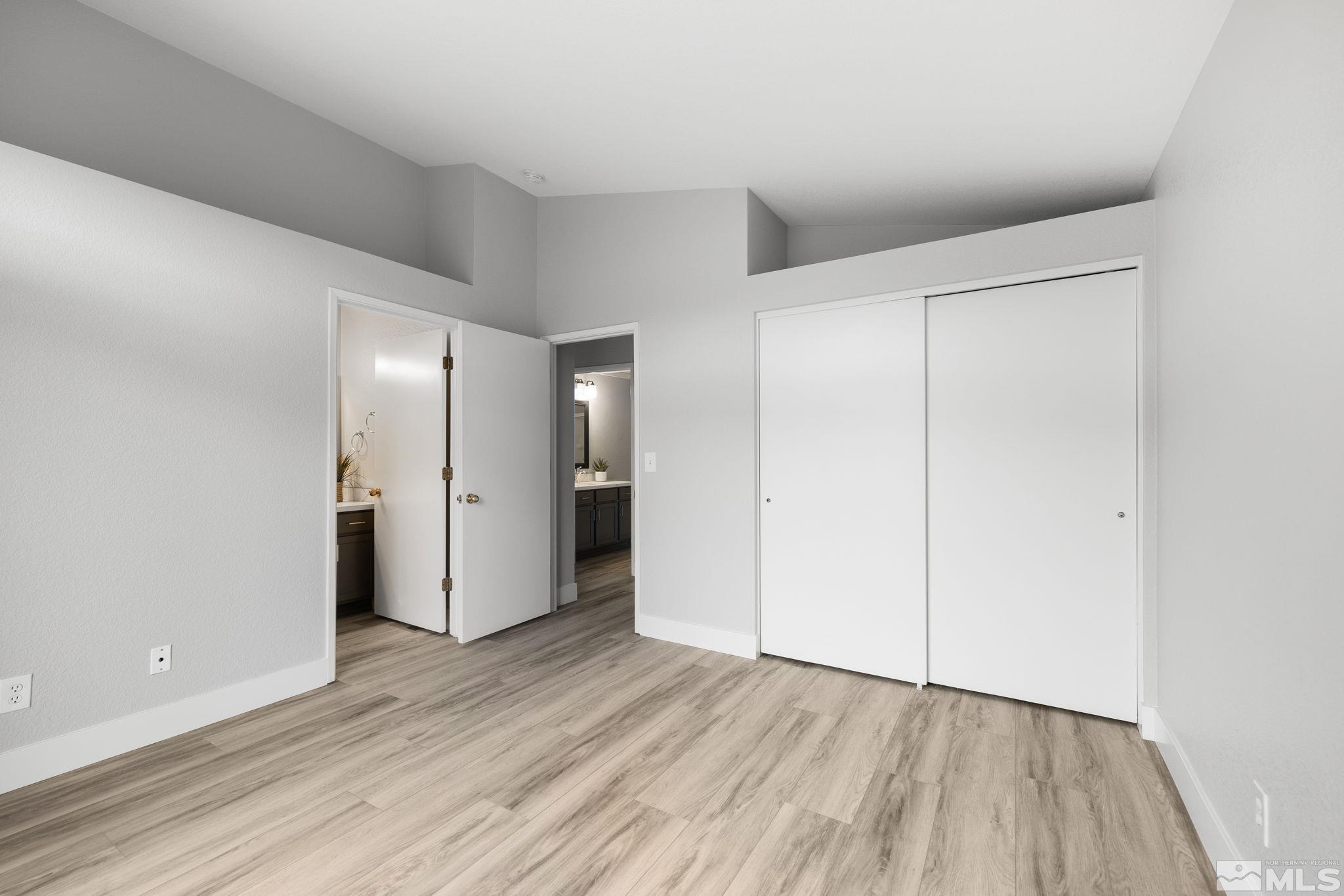 7577 Water View Way Reno, NV 89511 - Photo 15 of 20 a view of an empty room with wooden floor