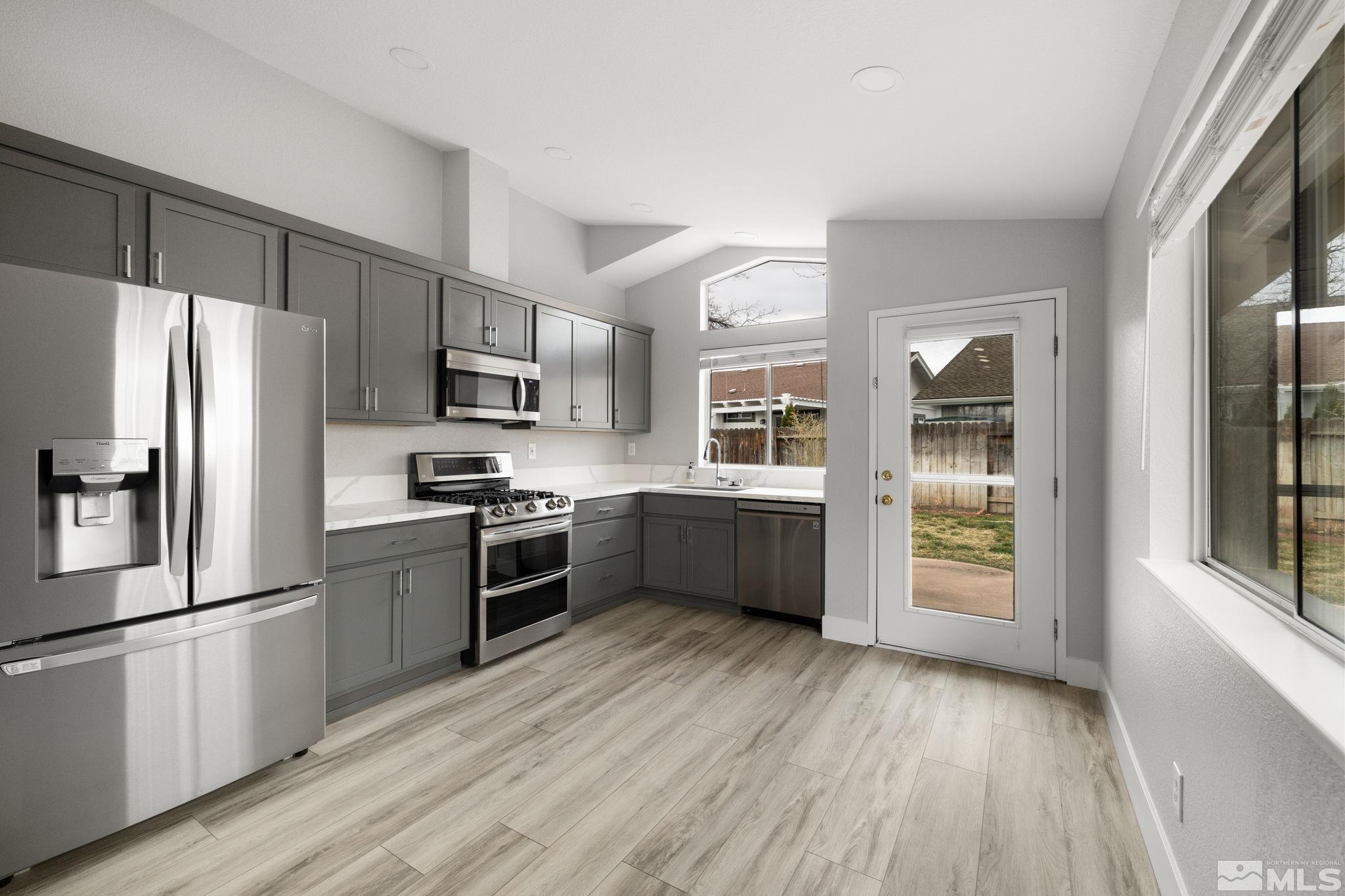 7577 Water View Way Reno, NV 89511 - Photo 5 of 20 a kitchen with stainless steel appliances a refrigerator and a stove top oven