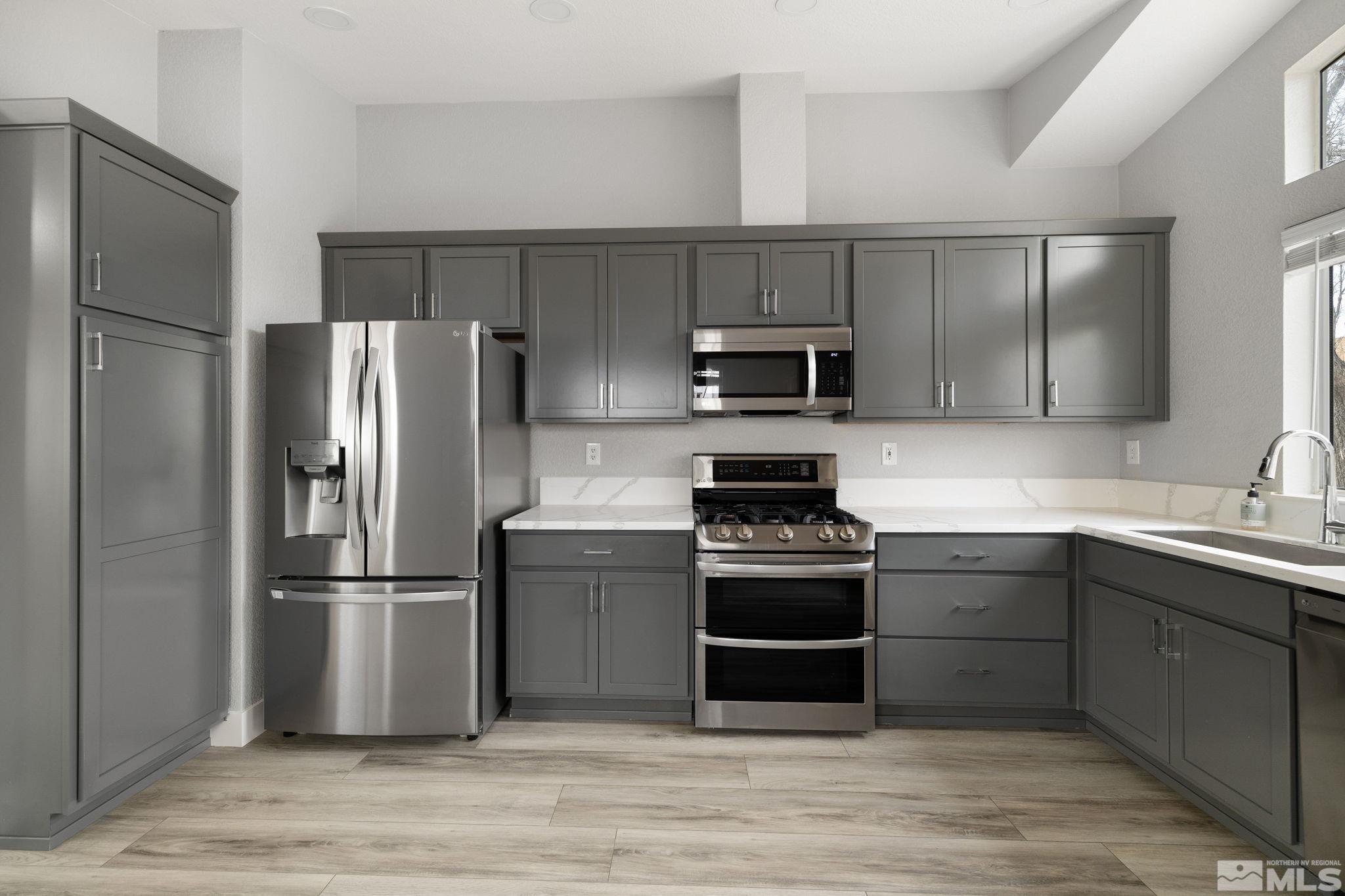7577 Water View Way Reno, NV 89511 - Photo 6 of 20 a kitchen with stainless steel appliances and wooden cabinets
