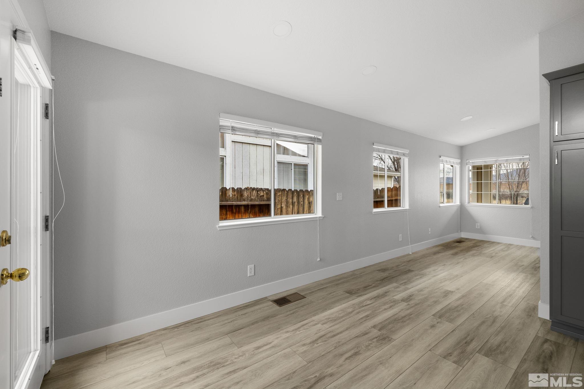 7577 Water View Way Reno, NV 89511 - Photo 7 of 20 an empty room with wooden floor and windows