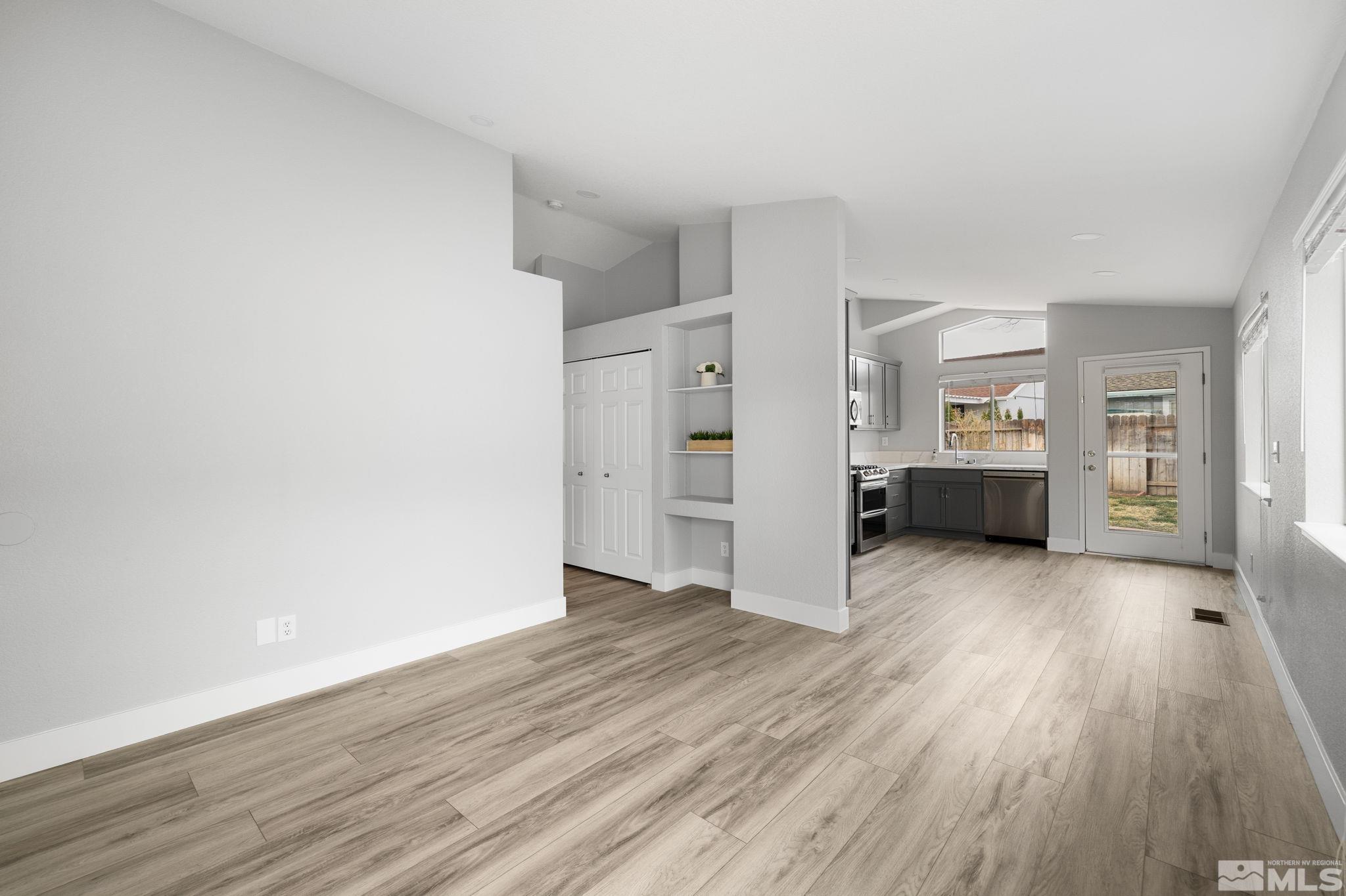 7577 Water View Way Reno, NV 89511 - Photo 9 of 20 an empty room with wooden floor and windows
