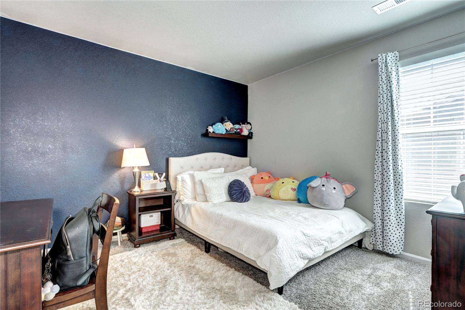 952 Morning Glory Road Brighton, CO 80640 - Photo 11 of 21 a bedroom with a bed and a tv