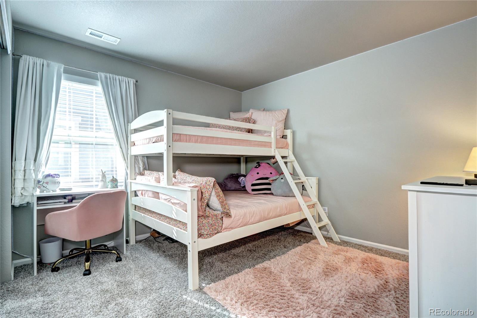 952 Morning Glory Road Brighton, CO 80640 - Photo 12 of 21 a bedroom with a bed and a window