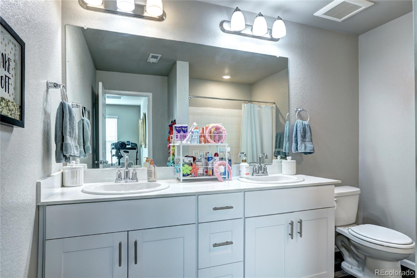 952 Morning Glory Road Brighton, CO 80640 - Photo 13 of 21 a bathroom with a sink vanity and a mirror