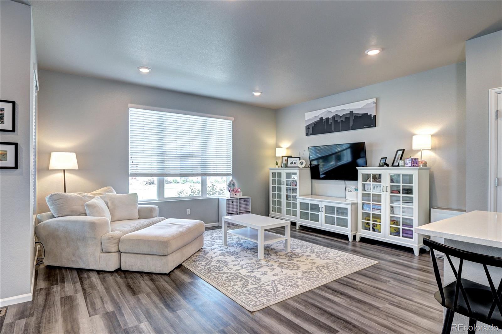 952 Morning Glory Road Brighton, CO 80640 - Photo 3 of 21 a living room with furniture and a flat screen tv