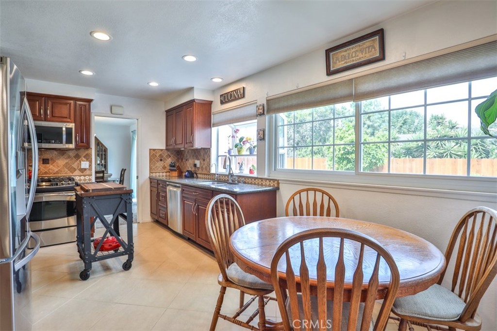 321 Blossom Place Brea, CA 92821 - Photo 14 of 50 a kitchen with a sink a refrigerator and chairs