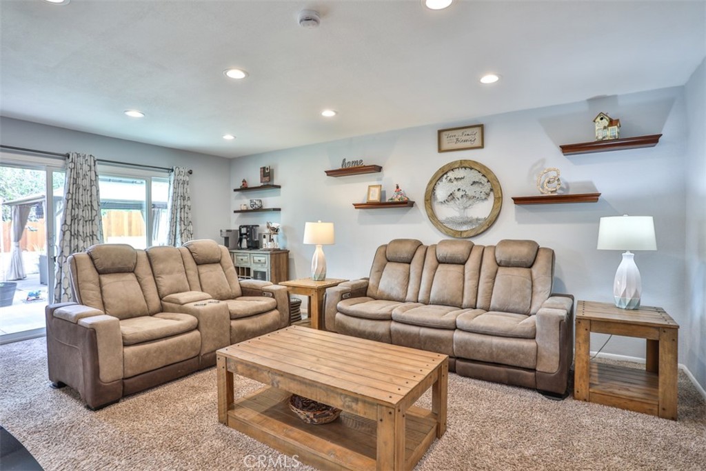 321 Blossom Place Brea, CA 92821 - Photo 15 of 48 a living room with furniture a clock tv and a window