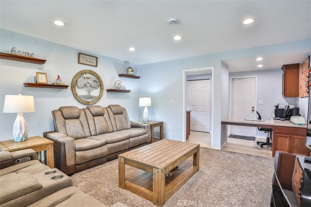 321 Blossom Place Brea, CA 92821 - Photo 19 of 50 a living room with furniture a clock on wall and a table