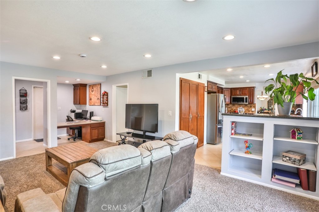 321 Blossom Place Brea, CA 92821 - Photo 20 of 50 a living room with furniture a flat screen tv and a refrigerator