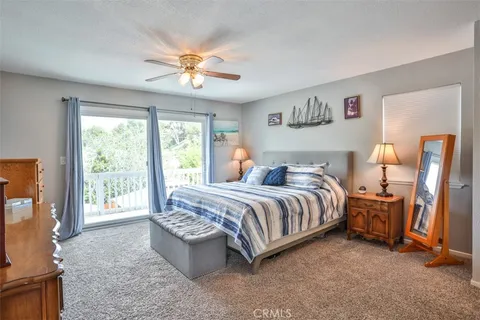 a spacious bedroom with a bed and a chandelier