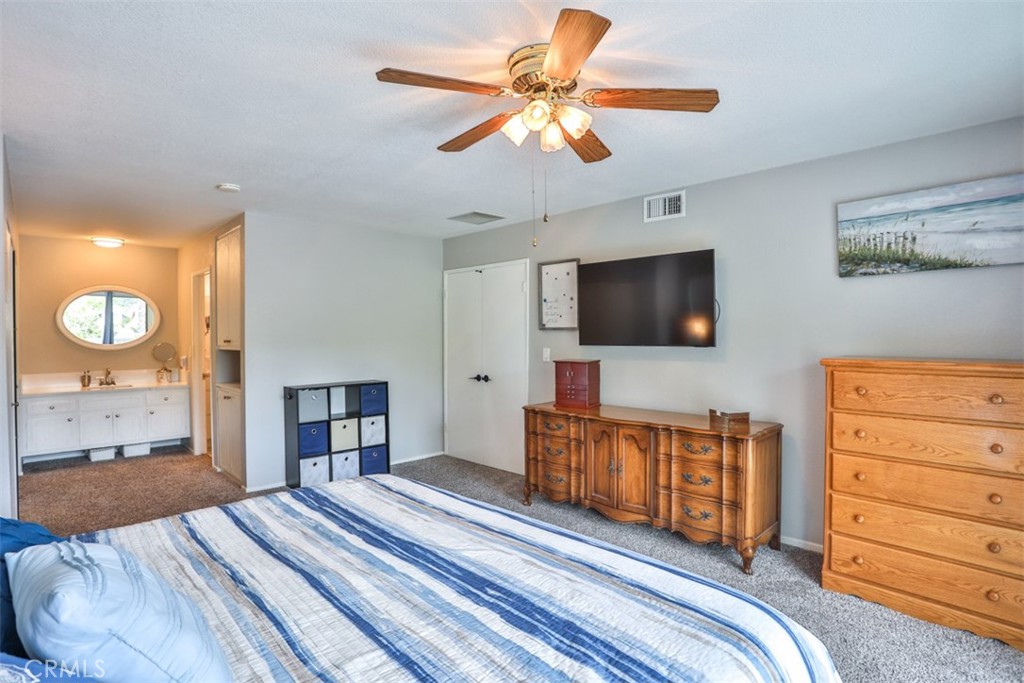 321 Blossom Place Brea, CA 92821 - Photo 24 of 48 a bedroom with a bed and a flat tv screen on dresser