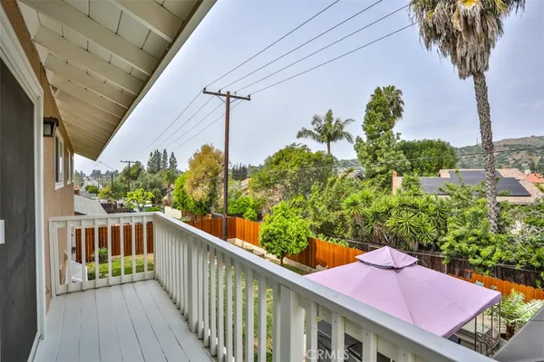 a view of a balcony with wooden floor