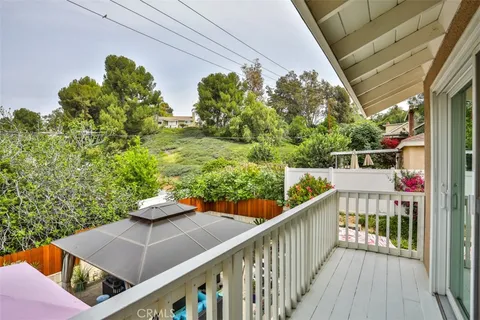 a view of a balcony with chairs