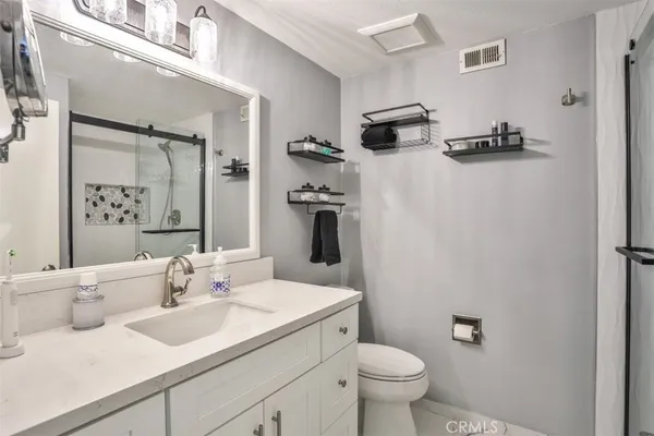 a bathroom with a sink toilet and shower