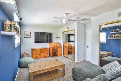 a bedroom with furniture and a flat screen tv