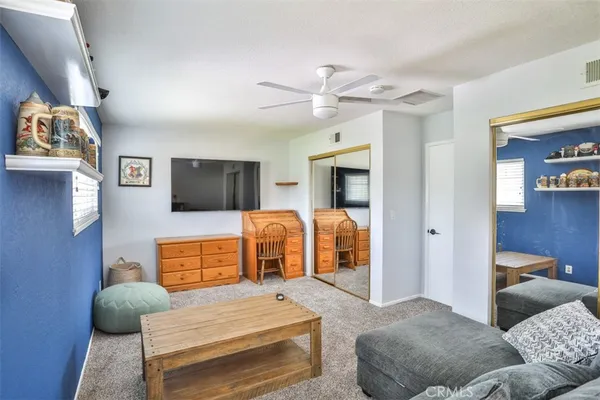 a bedroom with furniture and a flat screen tv