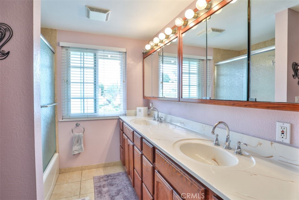 321 Blossom Place Brea, CA 92821 - Photo 37 of 50 a bathroom with a double vanity sink window and a bathtub