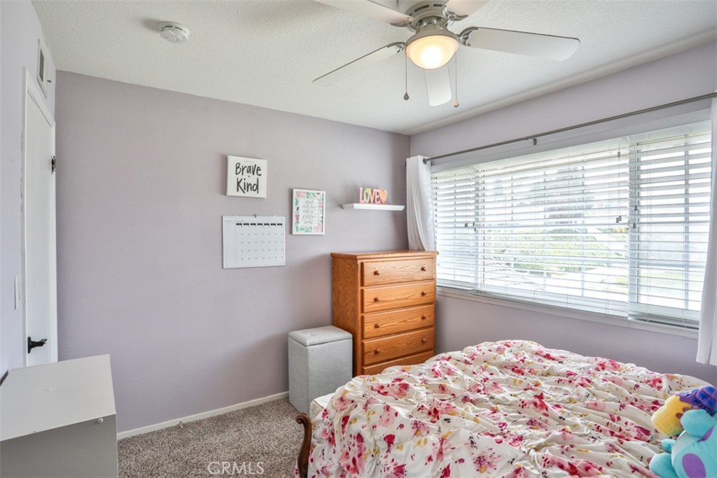 321 Blossom Place Brea, CA 92821 - Photo 39 of 48 a bedroom with a bed and a chandelier