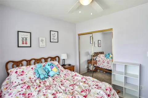 a bedroom with a bed and a dresser in it