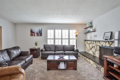 a living room with furniture a rug and a window