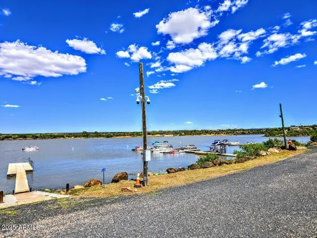 a view of a lake with a table under an umbrella