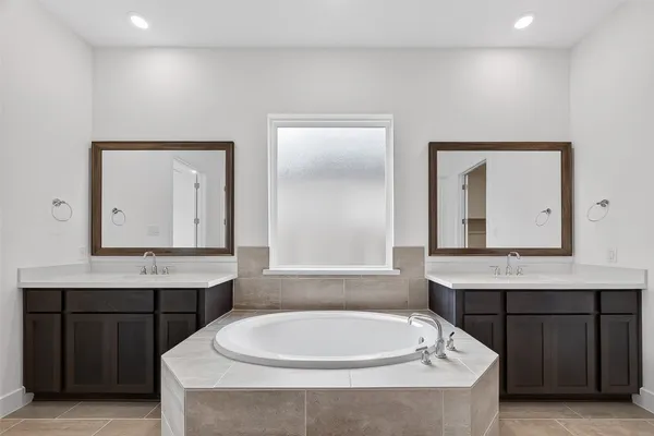 a bathroom with a bathtub a sink and a window