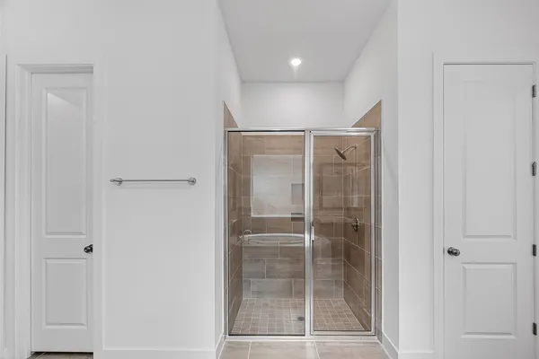 a bathroom with a glass shower door