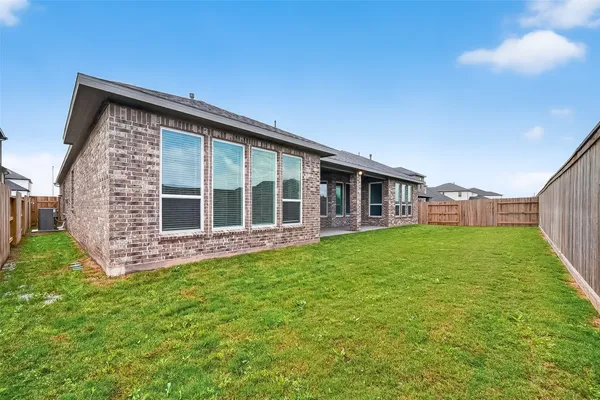 a view of a house with backyard and porch
