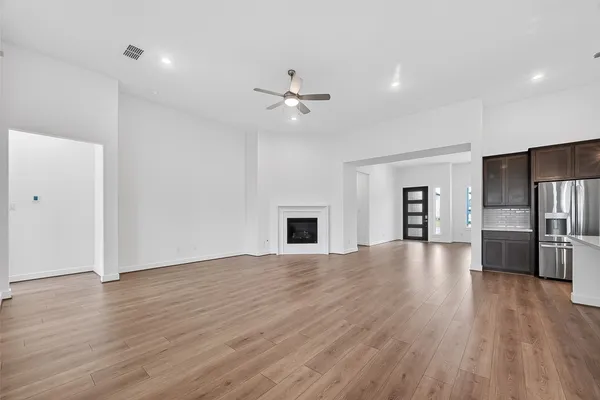 a view of a livingroom with wooden floor and a ceiling fan