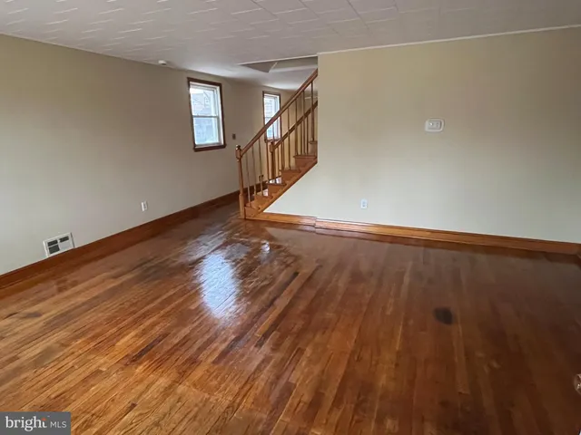 a view of a room with wooden floor and white walls