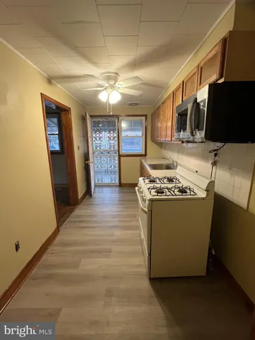 a room with wooden floors and chandelier