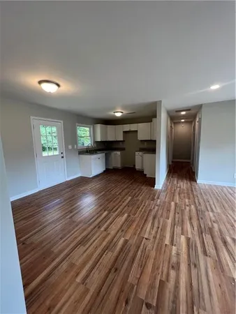 a view of a room wooden floor and a kitchen