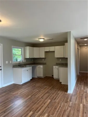 a kitchen with a refrigerator and a stove top oven