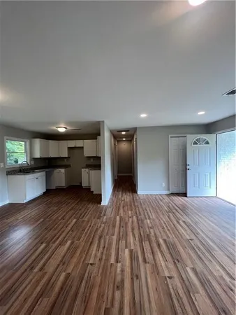 a view of empty room with wooden floor