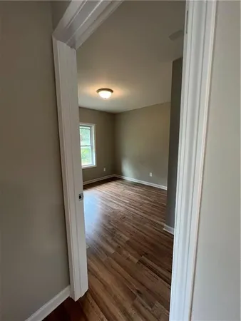 a view of hallway with wooden floor
