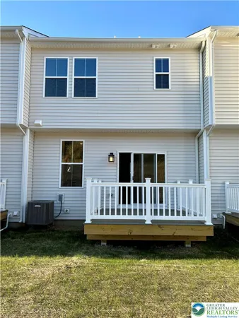a view of a house with a yard in the background