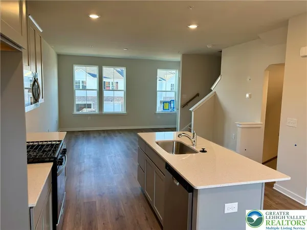 a kitchen with a sink a counter top space and a window