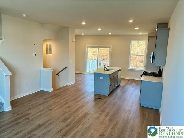 a large room with wooden floor and furniture