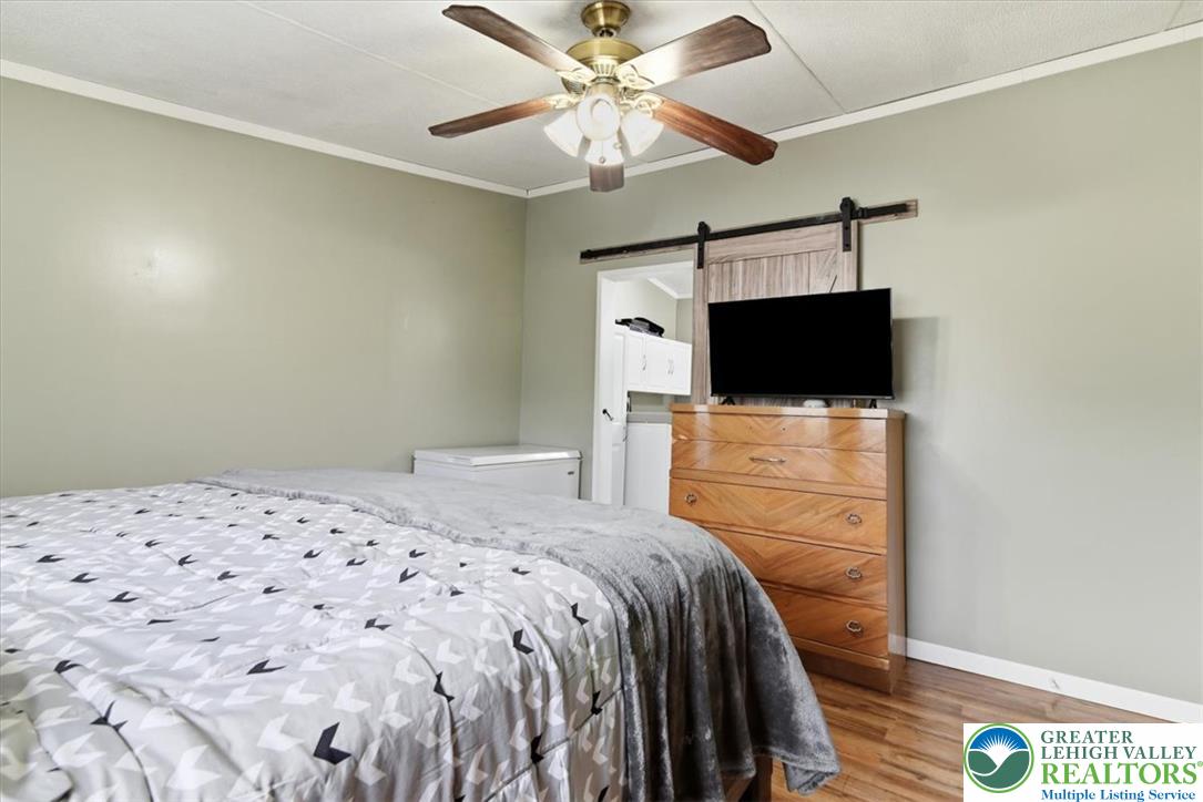 634 Main Road Lehighton, PA 18235 - Photo 20 of 39 Hardwood flooring and a ceiling fan create a comfortable and functional sleeping environment.