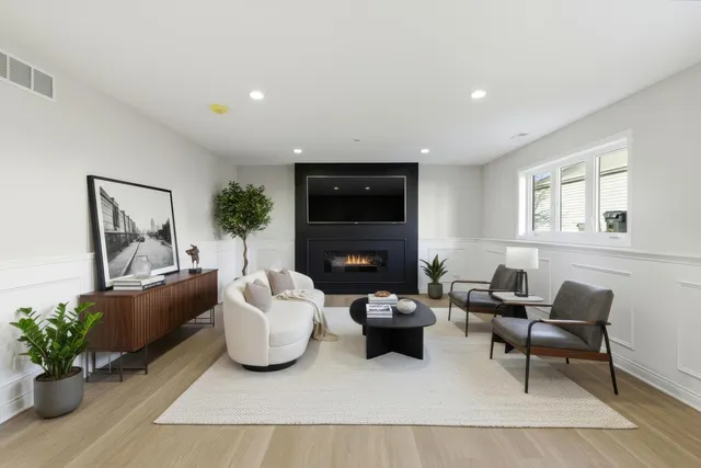 a living room with furniture potted plant and a fireplace