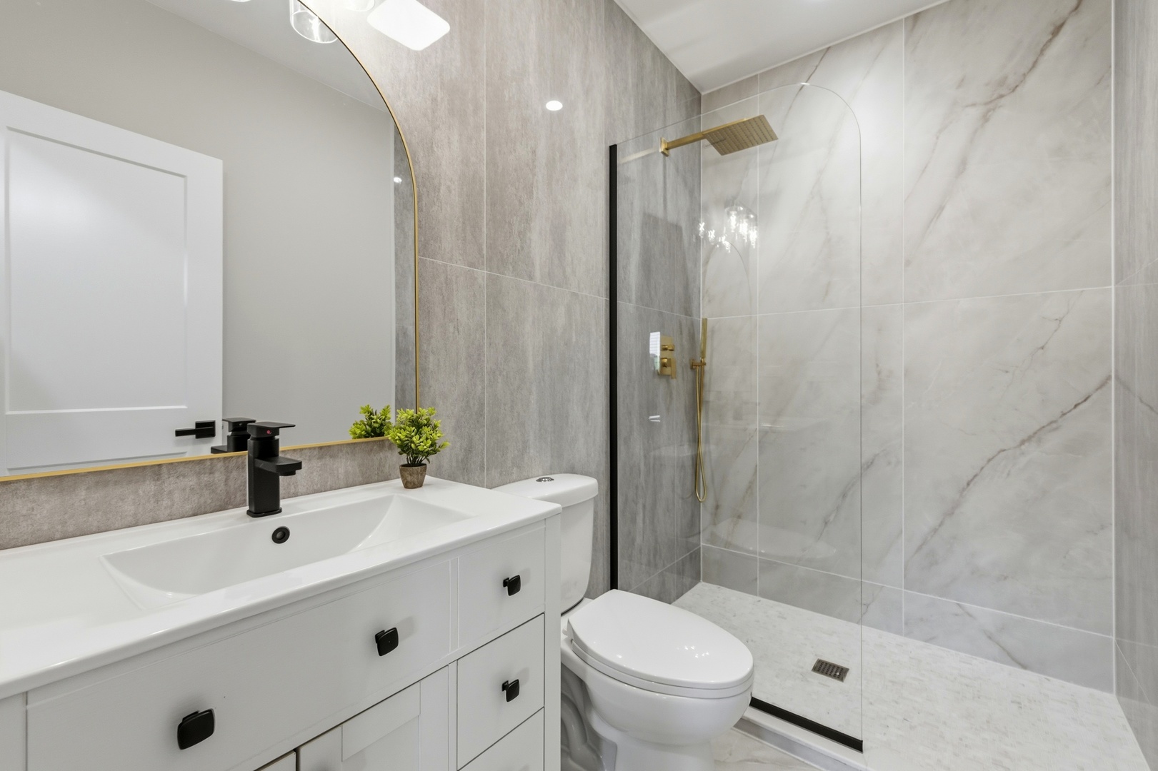 8332 South 77th Court Bridgeview, IL 60455 - Photo 12 of 26 a bathroom with a sink a toilet and shower
