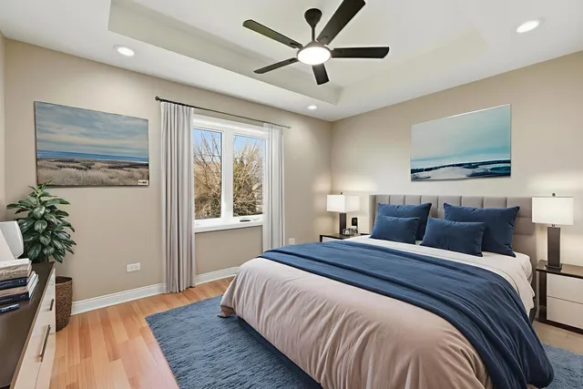 a bedroom with bed and a large window