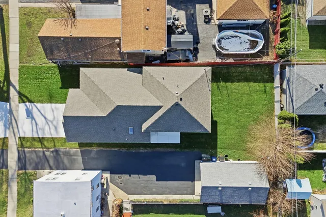 an aerial view of a house with a swimming pool