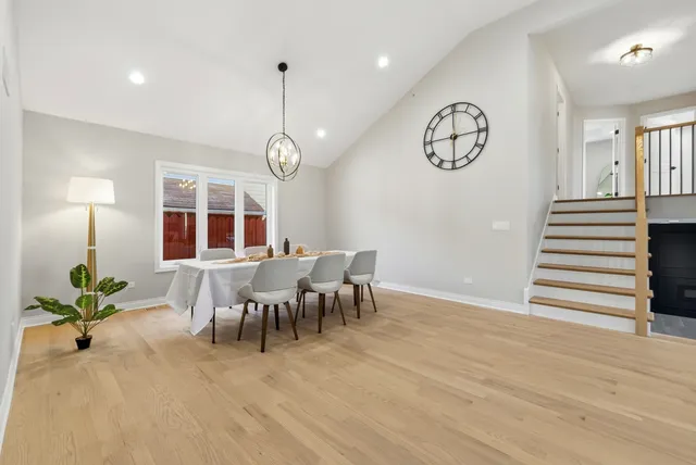 a view of a dining room with furniture and a chandelier