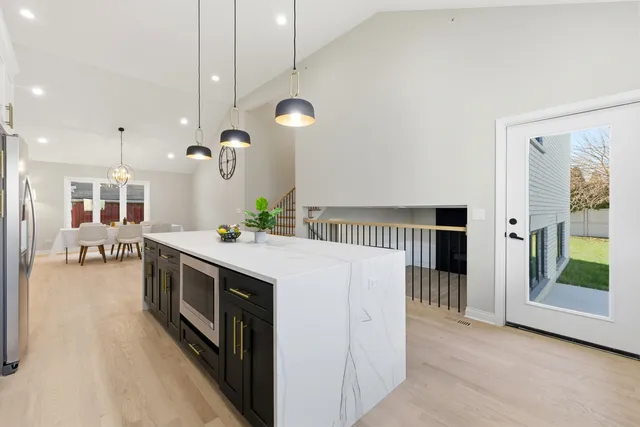 a kitchen with stainless steel appliances kitchen island a large island in the center