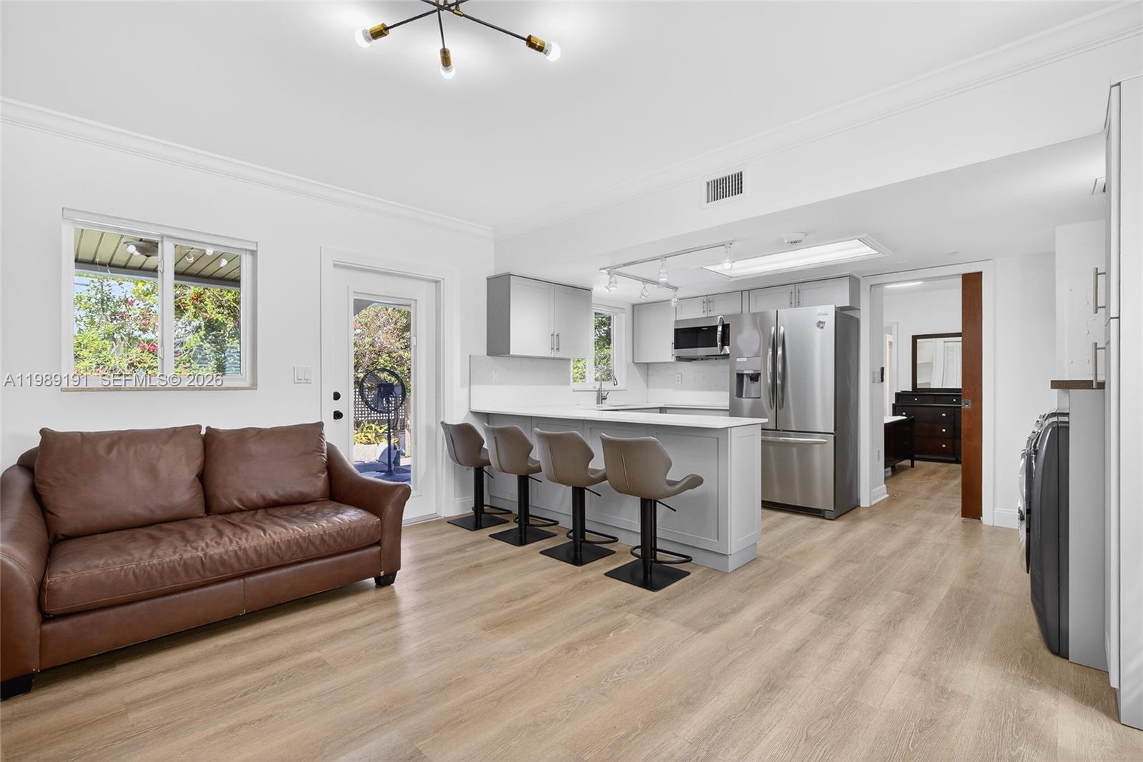 2431 Southwest 4th Street Miami, FL 33135 - Photo 11 of 33 a living room with furniture and a dining table with kitchen view