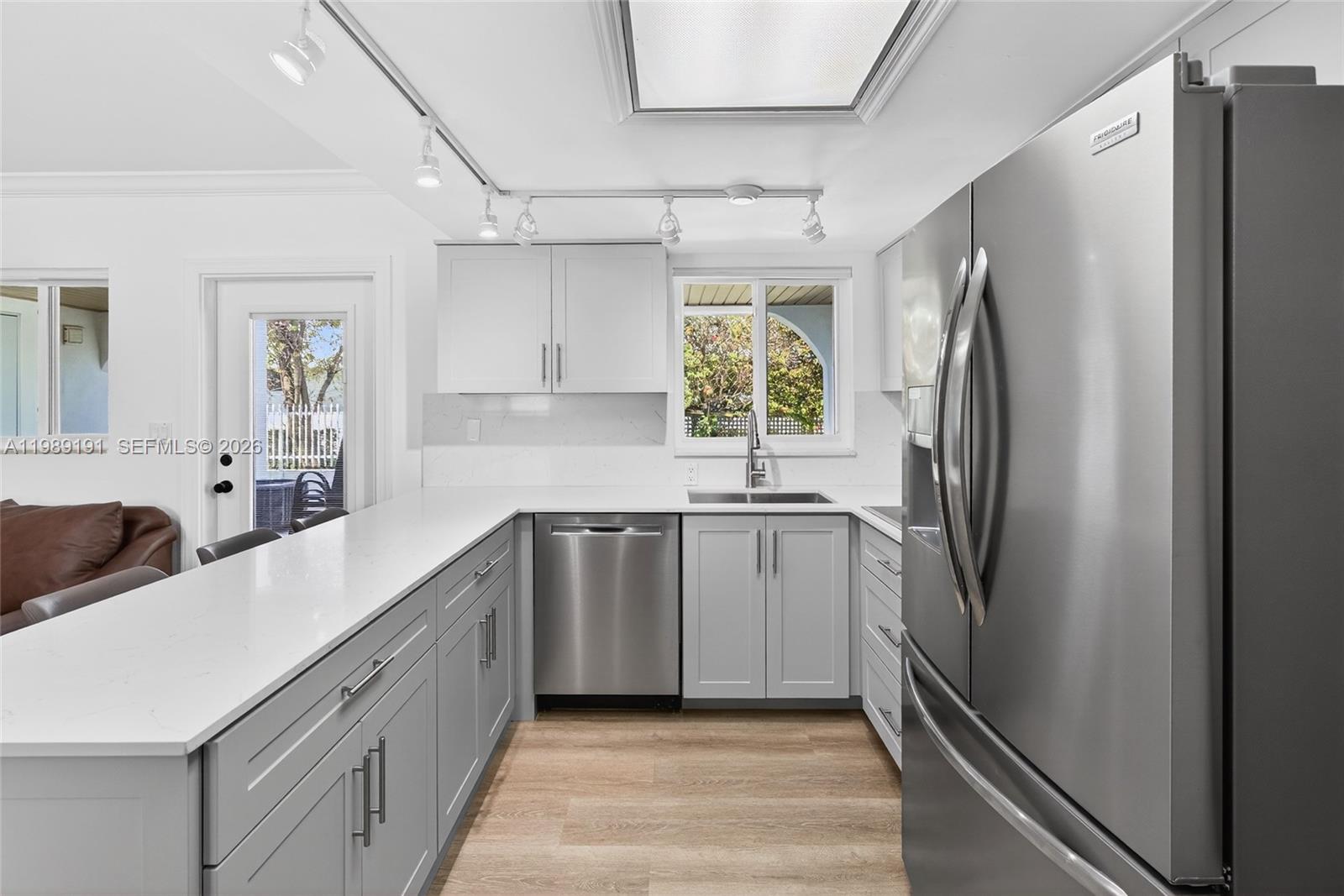 2431 Southwest 4th Street Miami, FL 33135 - Photo 13 of 33 a kitchen with stainless steel appliances a refrigerator sink and cabinets