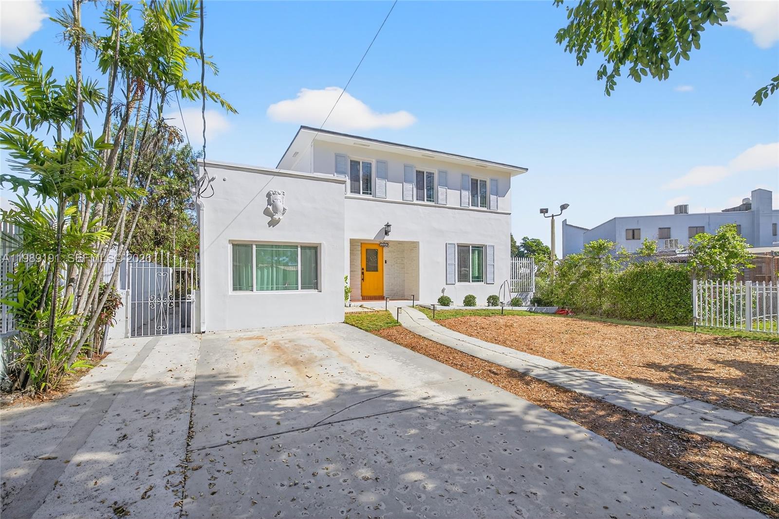 2431 Southwest 4th Street Miami, FL 33135 - Photo 2 of 33 a front view of a house with a yard and potted plants